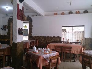 un restaurante con mesas y sillas en una habitación en Plaza Pueblo Hotel, en Vallegrande