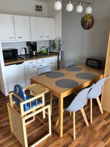 a kitchen with a table and chairs in a kitchen at FERIENWOHNUNG FORSTPANORAMA in Sankt Englmar