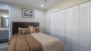 a bedroom with a bed with white cabinets and a sink at Spacious Cozy Condo! Perfect for longer stays in Mobile +12 photos