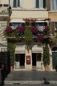 a building with lots of flowers and plants on it at Appartamento Benincampi in Rome
