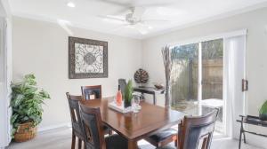 a dining room with a table and chairs and a ceiling fan at Spacious Cozy Condo! Perfect for longer stays in Mobile