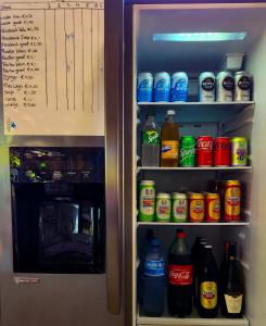 an open refrigerator filled with lots of drinks at Sutopia Holiday Resort in Meerzorg