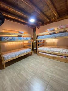 a room with three bunk beds in it at hermosa cabaña villa majo, cuenta con el espectacular rio santo domingo in San Francisco