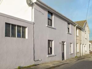 a white house on a street with at Horton View Cottage in Ferryside