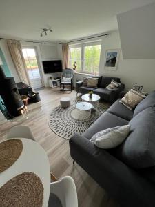 a living room with a couch and a table at Place to be Fehmarn in Fehmarn