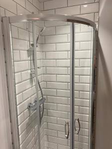 um chuveiro com uma porta de vidro na casa de banho em Maypole Farm, Cawood em Selby