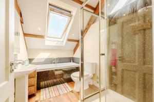a bathroom with a shower and a toilet and a sink at Ysgubor Uchaf in Troedyraur +35 photos