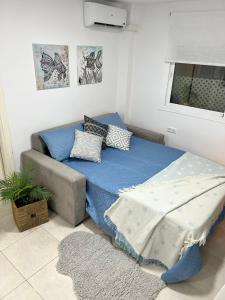 a small bedroom with a bed and a couch at Fuengirola Paseo Marítimo 27 in Fuengirola +25 photos
