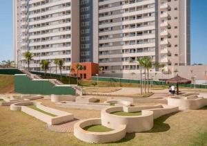 a park in front of a large building with buildings at Solar das Águas Resort in Olímpia