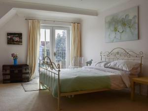 a bedroom with a large bed and a window at Atlas And Pearl in South Hayling