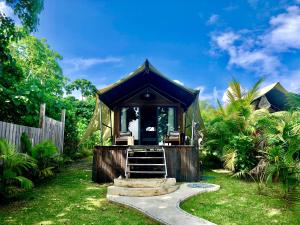 a gazebo in a garden with a path at Turtle Bay Lodge in Vitouara