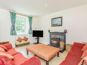 a living room with two couches and a fireplace at New Cottage in Farr