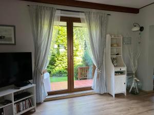 a living room with a sliding glass door at Bosio nad morze in Sztutowo