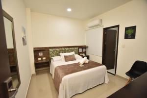 a bedroom with a bed and a chair in it at Hotel La Casa N. 3 in Montería