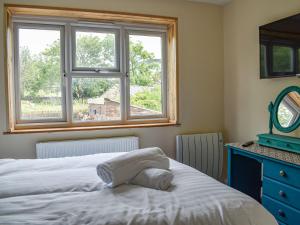 a bedroom with a bed and a window at Highgate in Brynkir