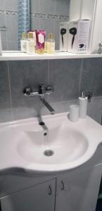 a white sink in a bathroom with a mirror at Apartman MAŠA in Jagodina