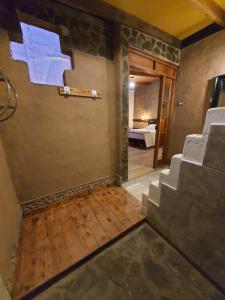 a room with stairs leading to a room with a bedroom at Lodge Don Felix in San Pedro de Atacama