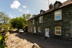 a stone house with a car parked in front of it at Oak Cottage Chapel Stile in Chapel Stile