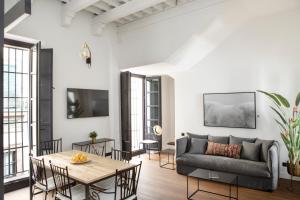 a living room with a couch and a table at Palacete Molina in Seville