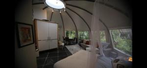 a living room with a couch and some windows at Unique private guesthouse 'The Iglo' in Paterswolde +28 photos