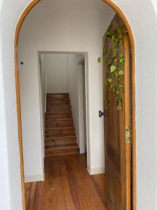 an archway leading into a hallway with a staircase at Travelers House in Setúbal