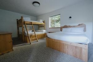 a bedroom with two bunk beds and a ladder at Wild Coast Wilderness Resort in Port Renfrew