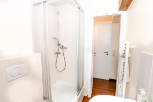 a bathroom with a shower with a glass door at Pension Ferber in Monheim