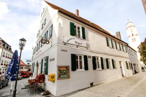a white building on the side of a street at Pension Ferber in Monheim
