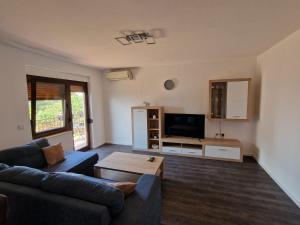 a living room with a couch and a tv at Villa Bravo in Podstrana