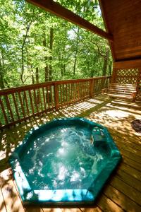 a hot tub on the deck of a cabin at Gatlinburg Adventure Cabins in Sevierville