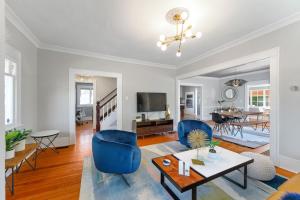 a living room with blue chairs and a table at Beautiful, Historic Home, heart of McMinnville. in McMinnville