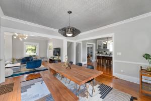 a living room with a wooden table and blue chairs at Beautiful, Historic Home, heart of McMinnville. in McMinnville
