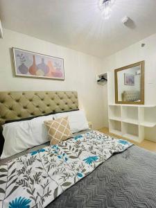 a bedroom with a large bed with a large headboard at Spacious 2 bedroom 42sqm condo unit in Iloilo City +26 photos