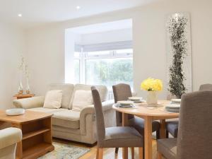a living room with a couch and a table at Princess Court Apartment in Llanelli