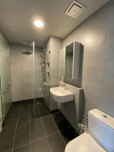 a bathroom with a sink and a shower and a toilet at Alawa @ Jesselton Quay Kota Kinabalu in Kota Kinabalu