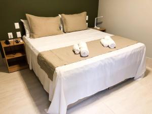 a bedroom with a bed with towels on it at HOTEL CORTESE in Teresina