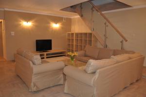 a living room with two couches and a tv at Apartament w centrum in Krakow