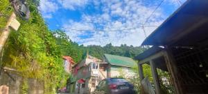 a view of a street with a car parked on the street at Dik's Home in Darjeeling