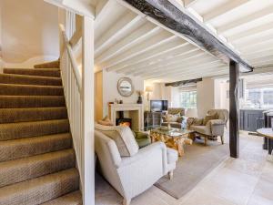 a living room with stairs and a living room at Hope Cottage in Longborough