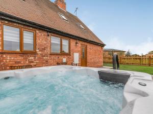 a hot tub in the backyard of a house at The Old Farmhouse in Longford