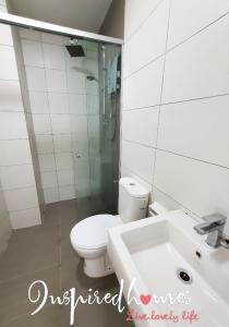 ein weißes Bad mit einem WC und einem Waschbecken in der Unterkunft Inspired Homes @ PJ Grand Sofo#3A in Petaling Jaya