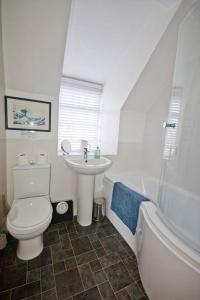 a bathroom with a toilet and a sink at Duck Cottage - Pet-friendly Traditional Rural Home in Kilrenny