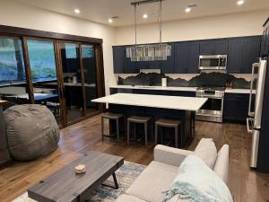 a large kitchen with a table and a couch at Whitefish Slopeside Condo in Whitefish