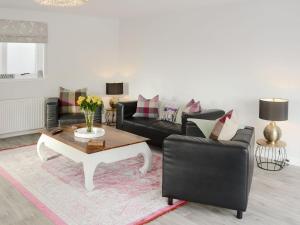 a living room with a couch and a coffee table at Rose Cottage in Dingwall