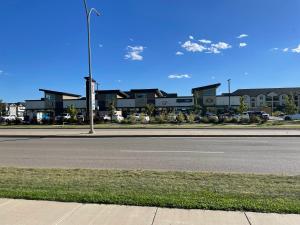 an empty street with a traffic light and houses at Hamm Suite in Saskatoon