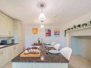 a kitchen with a long island with a counter top at Bank House Apartment in Newnham