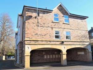 a large brick building with a large garage at Beautiful Cottage In Alnwick With 2 Bedrooms And Wifi in Alnwick
