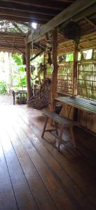 a wooden bench sitting inside of a building at Antonio's ko yao noi BED & Pool in Ko Yao Noi