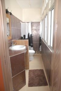 a bathroom with a sink and a toilet at Maison d'hôtes Opanoramic in Dakar +50 photos