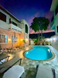 a swimming pool in the middle of a courtyard at night at The Villa Residences Resort in Patong Beach